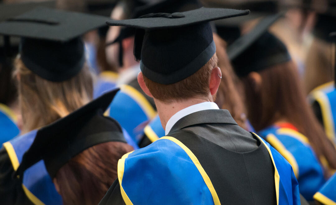 Lincoln, UK, September 10, 2014. Students sit in a row at their university graduation ceremony