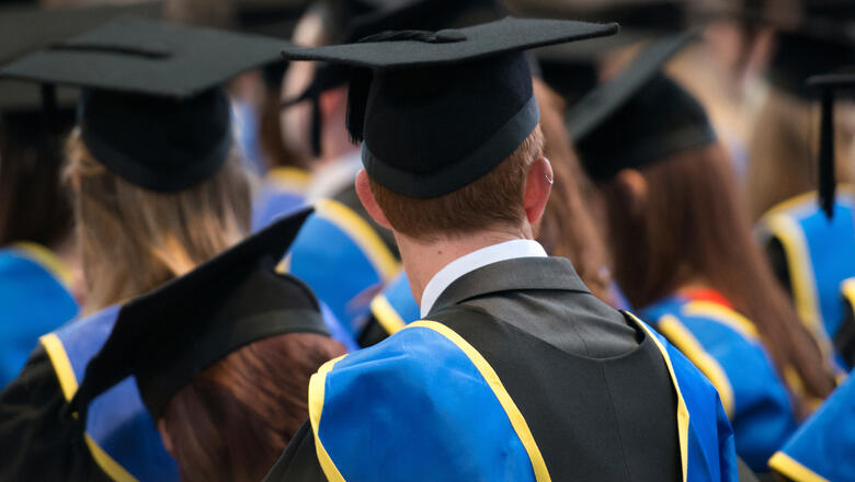 Lincoln, UK, September 10, 2014. Students sit in a row at their university graduation ceremony