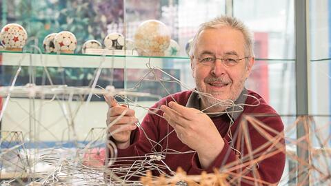 Jürgen Richter-Gebert baut mit Kleiderbügeln geometrische Formen (Foto: Astrid Eckert/TUM)